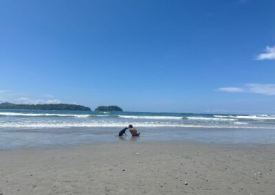 Woman kisses dog at empty beach in Costa Rica